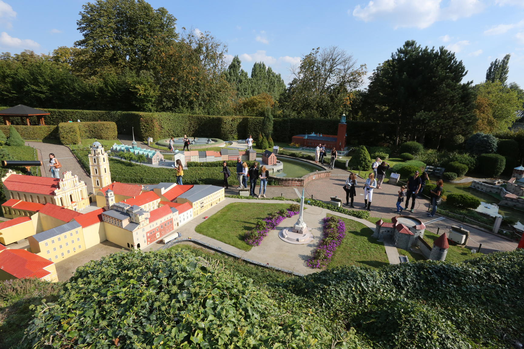 Visitors walking along the paths of Mini-Europe around the Vilnius miniatures.